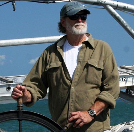 David Nichols at the wheel of a sailboat